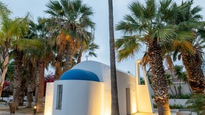 A modern building with a dome, surrounded by palm trees and a clear sky. - Elias Beach Hotel (Limassol)
