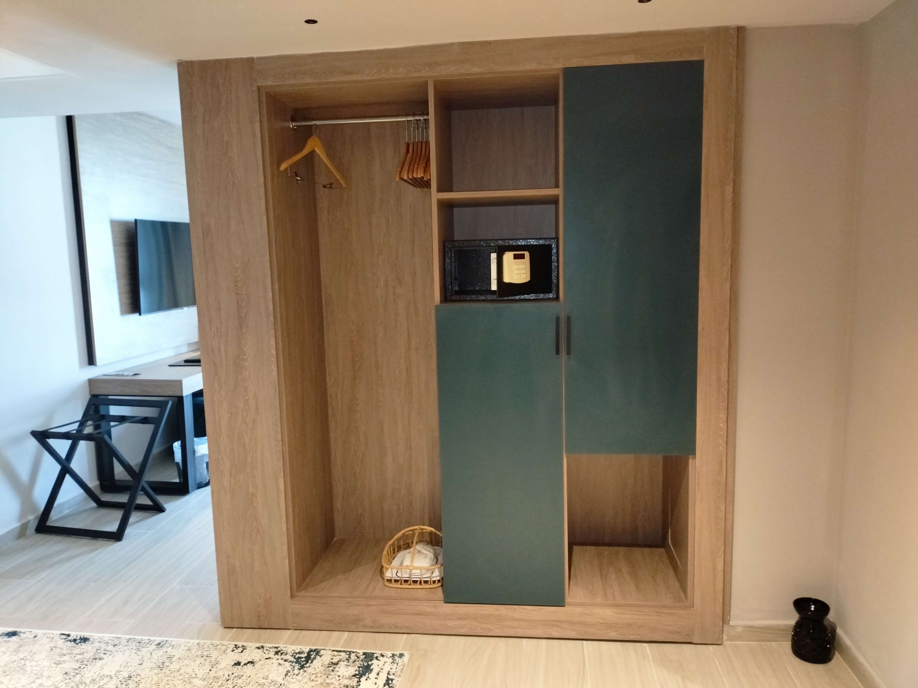 A modern room with a wooden wardrobe, a desk, and a chair.