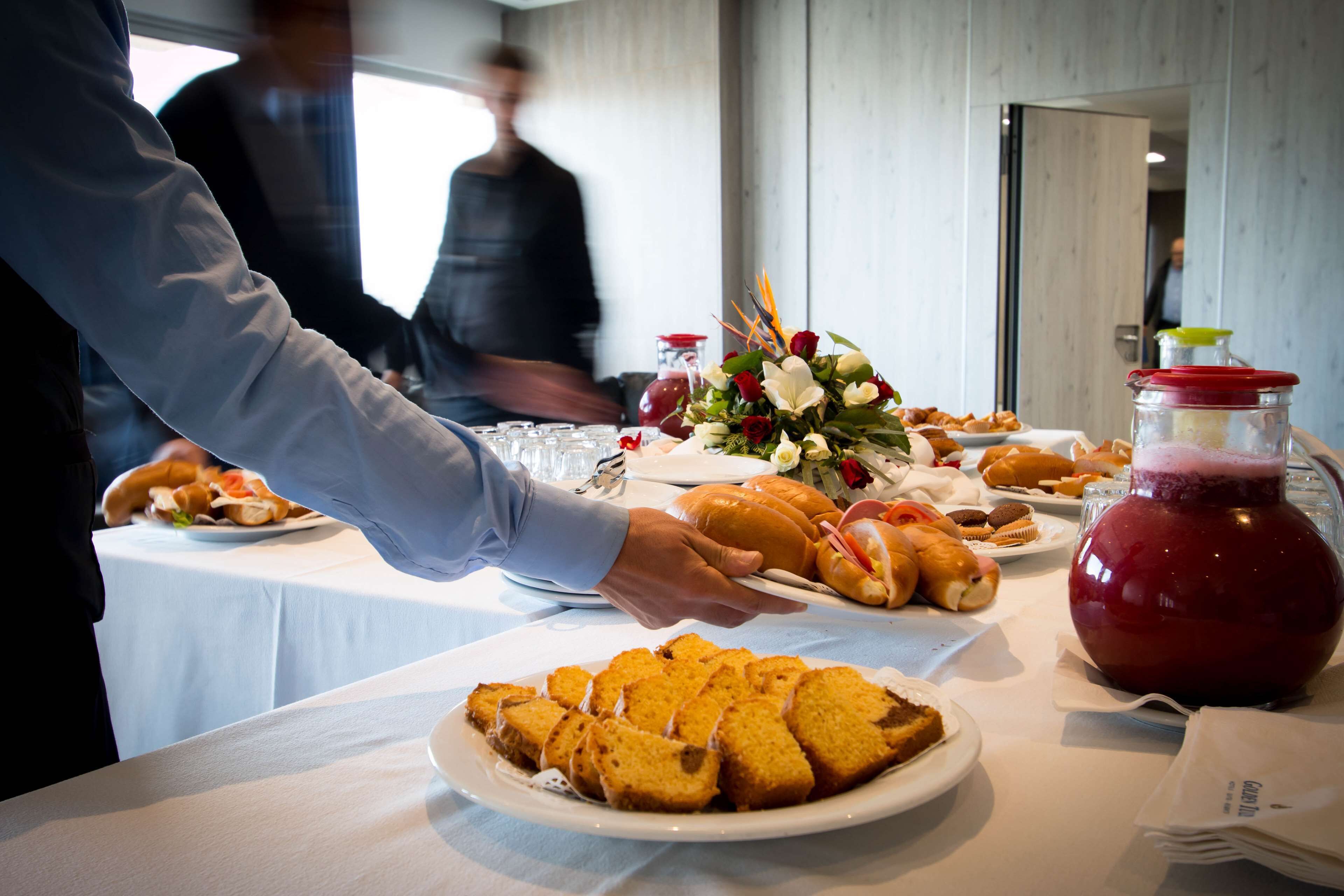 Ein Buffet mit verschiedenen Speisen und einer Karaffe rotem Getränk.