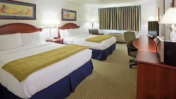 A hotel room with two beds, a desk, a chair, and a television.