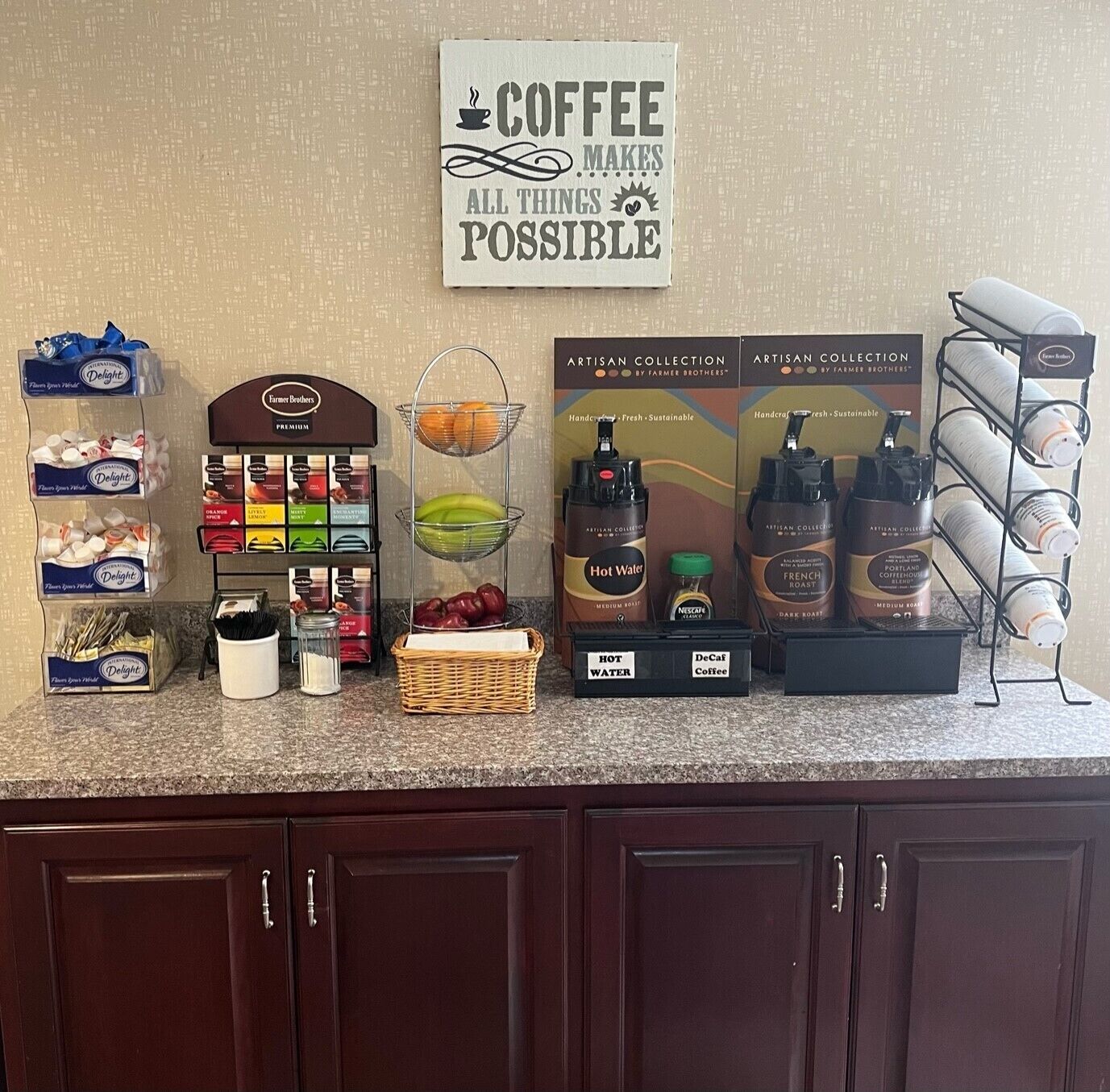 A coffee station with various coffee products and a sign that reads "COFFEE MAKES ALL THINGS POSSIBLE".