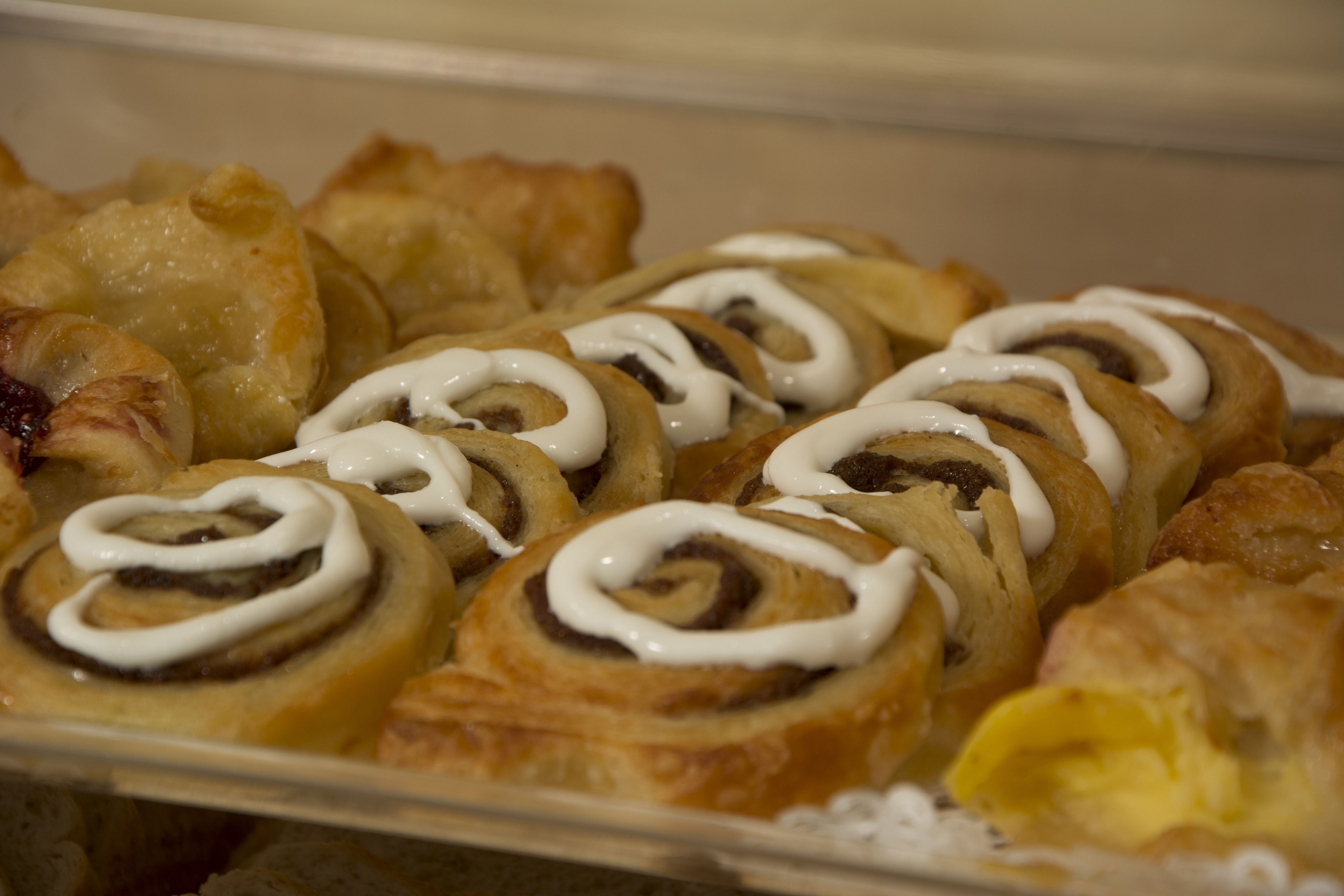 A tray of assorted pastries including cinnamon rolls and other baked goods.