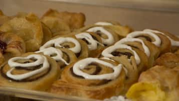 A tray of assorted pastries including cinnamon rolls and other baked goods.