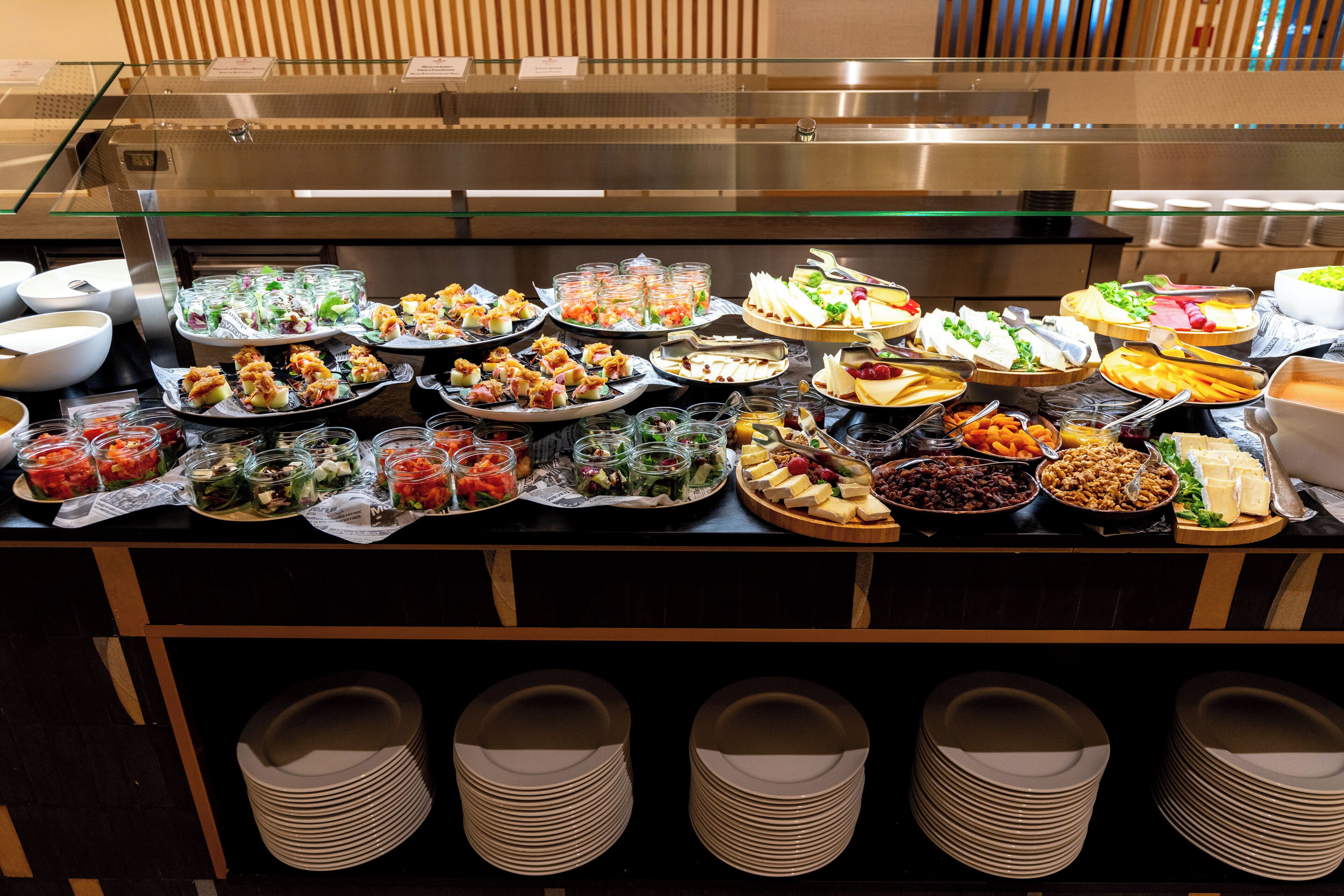 A buffet with various food items and a glass display case.