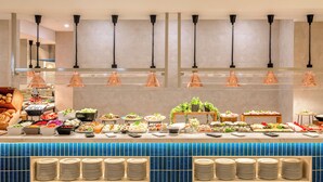 A buffet setup with various food items and stacked plates. - Hotel Las Arenas, Affiliated by Meliá (Benalmádena)
