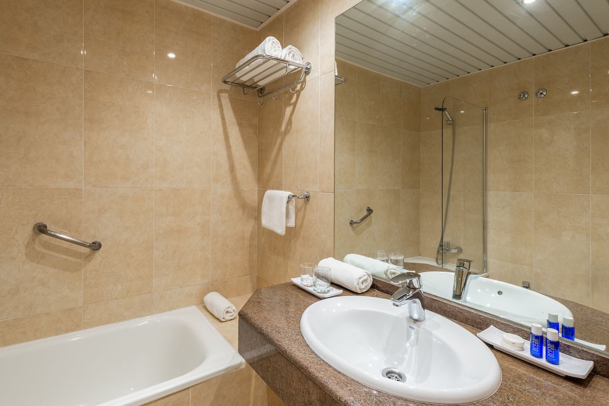 designer toiletries, hair dryer, towels, soap