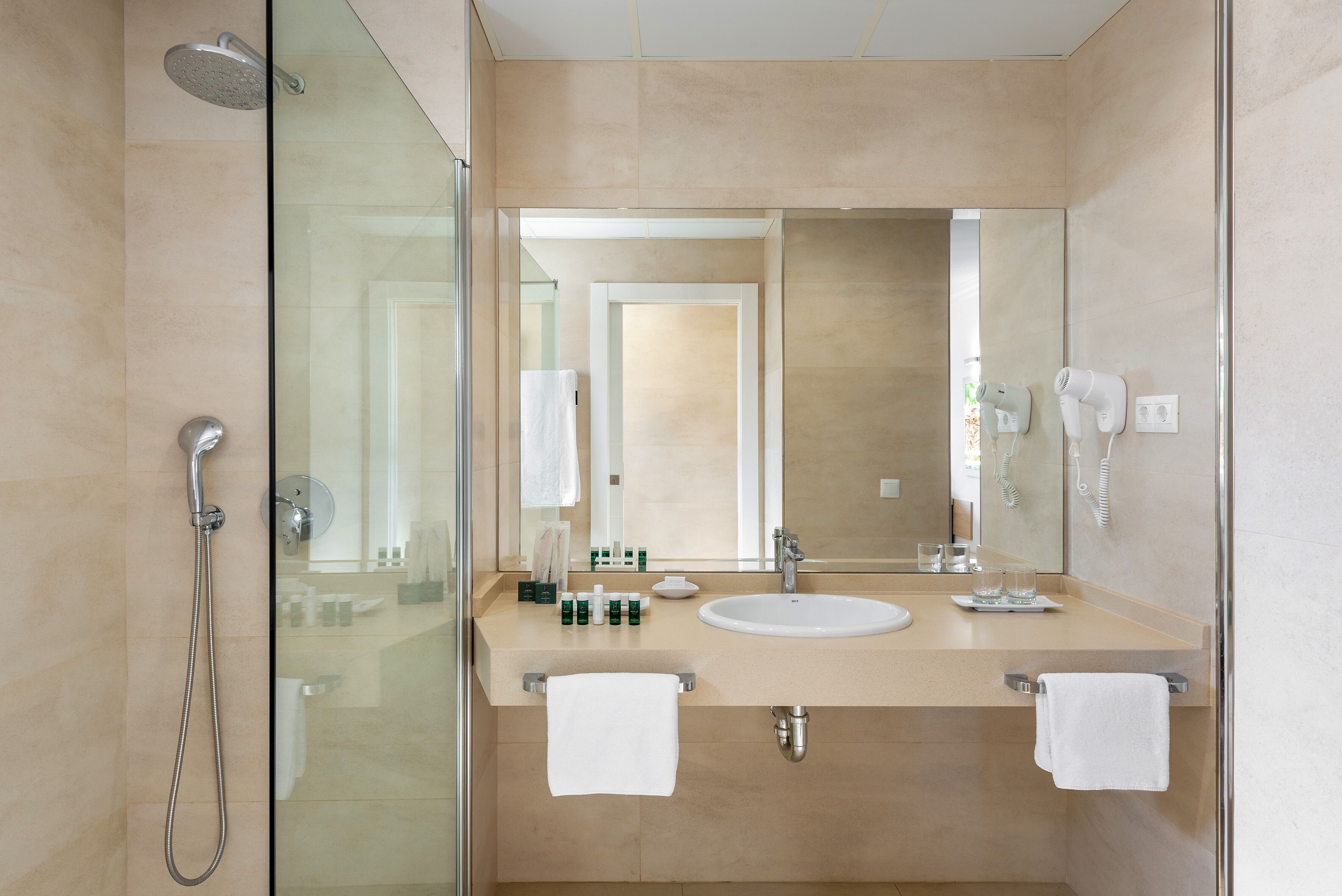 designer toiletries, hair dryer, towels, soap