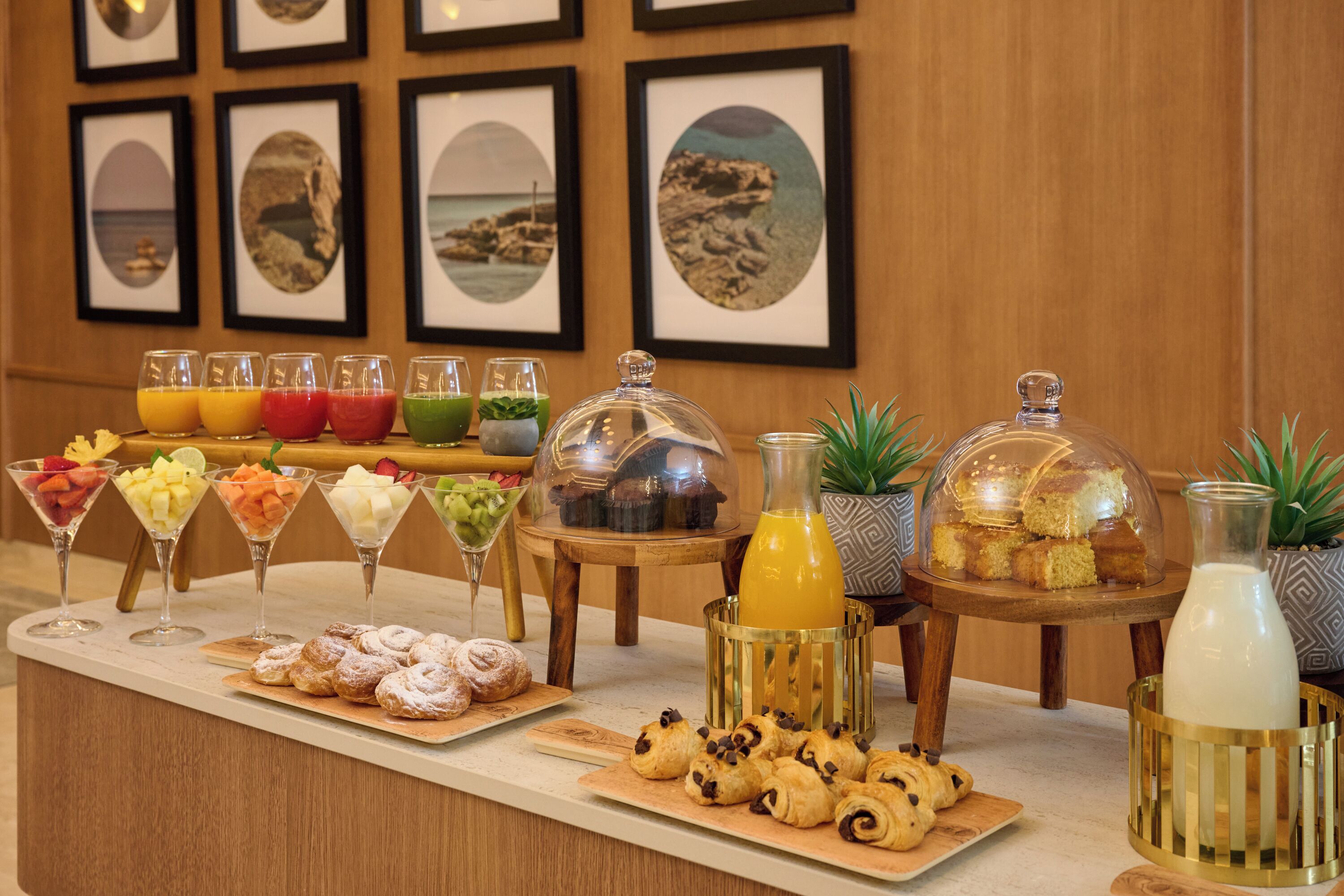 A breakfast buffet with various food items and drinks.