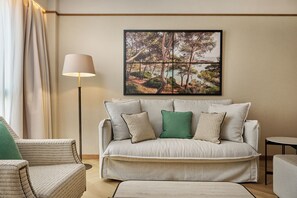 A living room with a sofa, two armchairs, a floor lamp, and a framed landscape painting on the wall. - Hipotels Hipocampo Palace & Spa (Sant Llorenc des Cardassar)