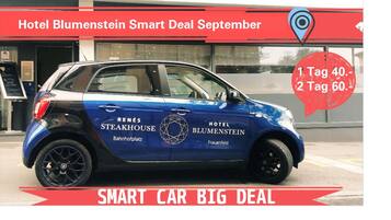 A blue car with "Hotel Blumenstein" and "Renés Steakhouse" branding parked in front of the hotel.