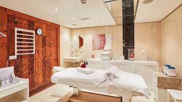 Relax in a serene space with a neatly made bed, bedside table, and large mirror.
