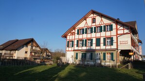 A traditional half-timbered building with a sign indicating it is a restaurant and hotel. - Hotel Bahnhof (Schupfen)
