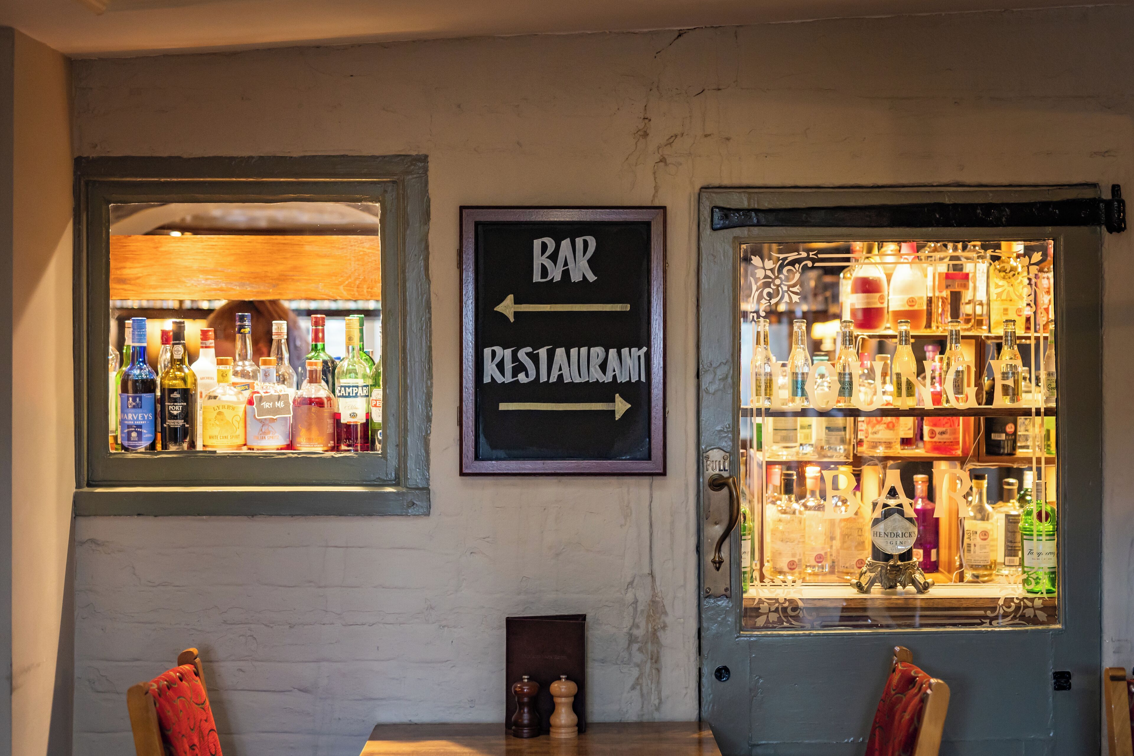 A bar area with a sign indicating the direction to the bar and restaurant.