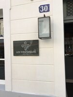 A sign for "Les Tourelles Hotel Paris" with a number '30' above it.