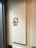 A wall with a decorative number '53' and a small heart-shaped ornament.