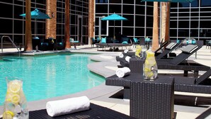 A poolside area with lounge chairs, umbrellas, and a clear view of the pool.