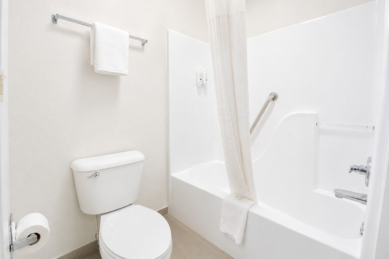 Standard Room, 2 Queen Beds, Non Smoking | Bathroom | Hydromassage showerhead, hair dryer, towels
