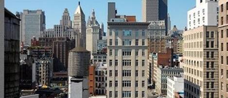 A high-rise building with a classic architectural style, featuring multiple windows and a prominent corner tower.