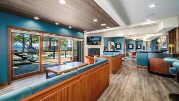 A restaurant with wooden paneling, blue walls, and a view of outdoor seating.