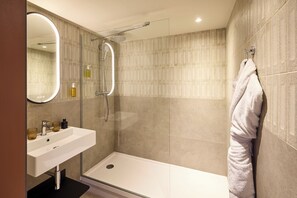 A modern bathroom with a glass-enclosed shower, a white sink, and a towel rack. - You Hotel de France Valence - Handwritten Collection. T3 26 (Valence)