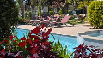 Seasonal outdoor pool, open 8:00 AM to 9:00 PM, pool umbrellas