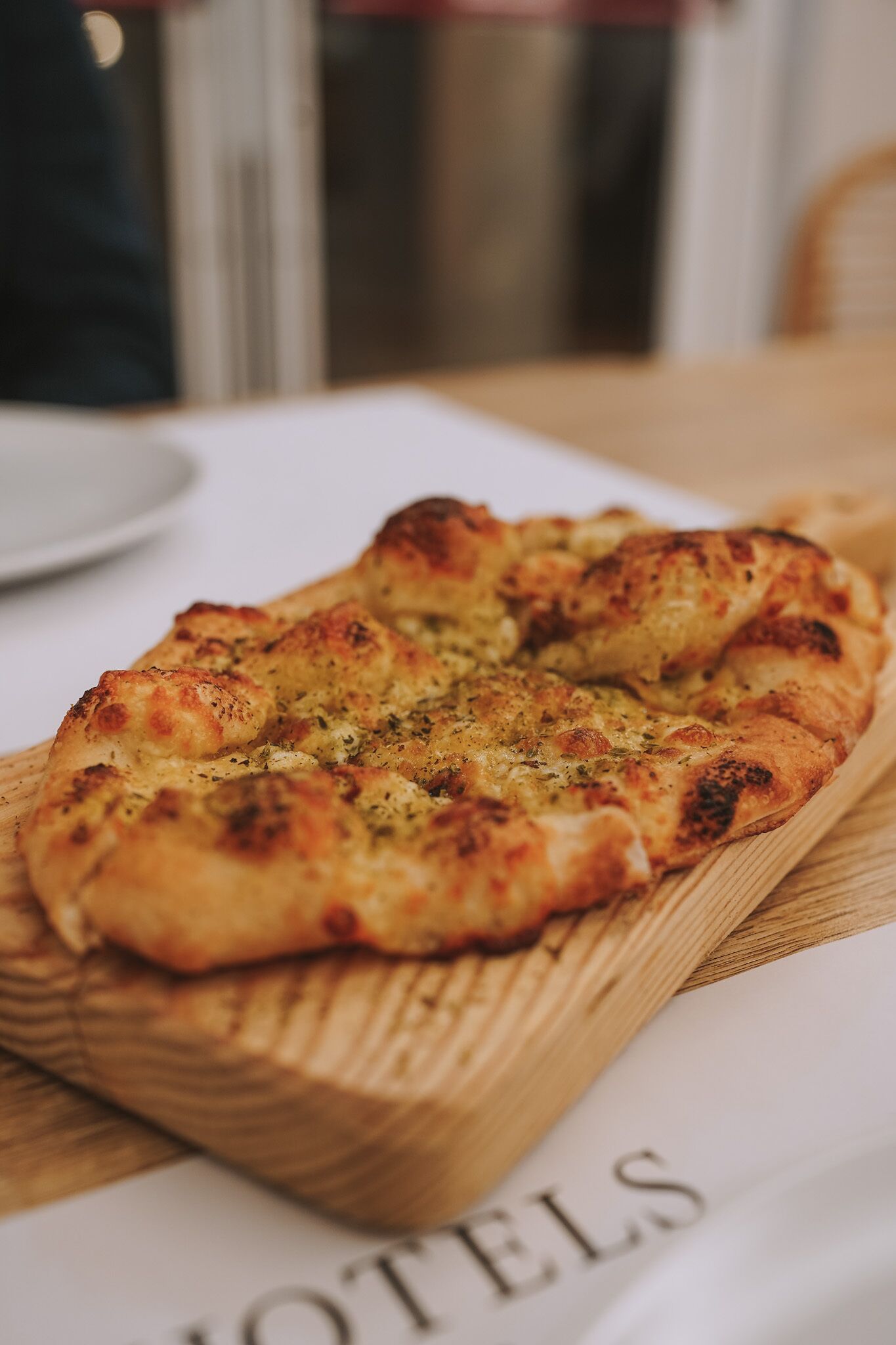 A pizza on a wooden board.