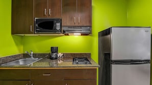 A kitchen with a microwave, stove, and refrigerator. - Studio 6 Extended Stay - Atlanta, GA - Chamblee (Chamblee)