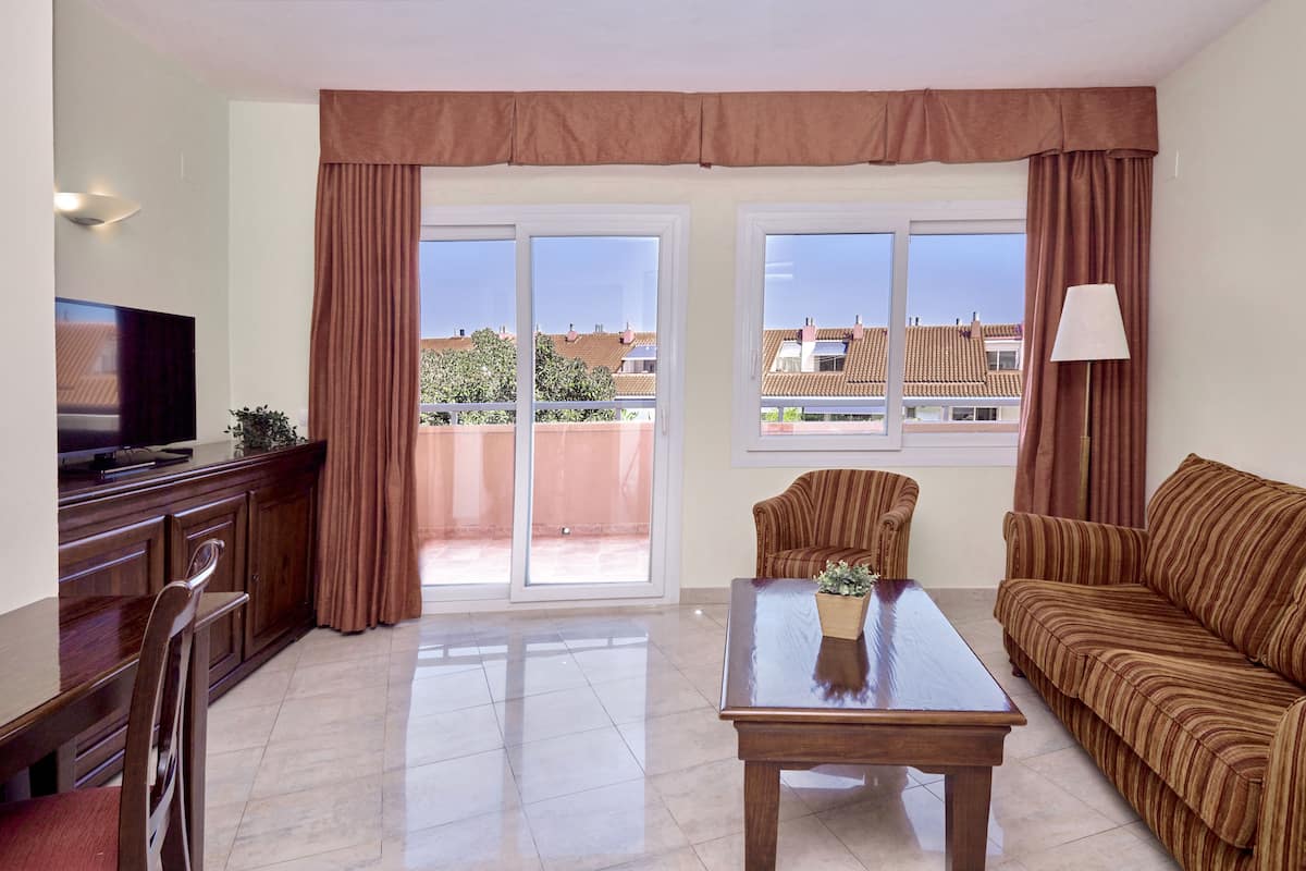 family apartment, pool view | living area | 26-inch flat-screen tv with satellite channels, tv, table football