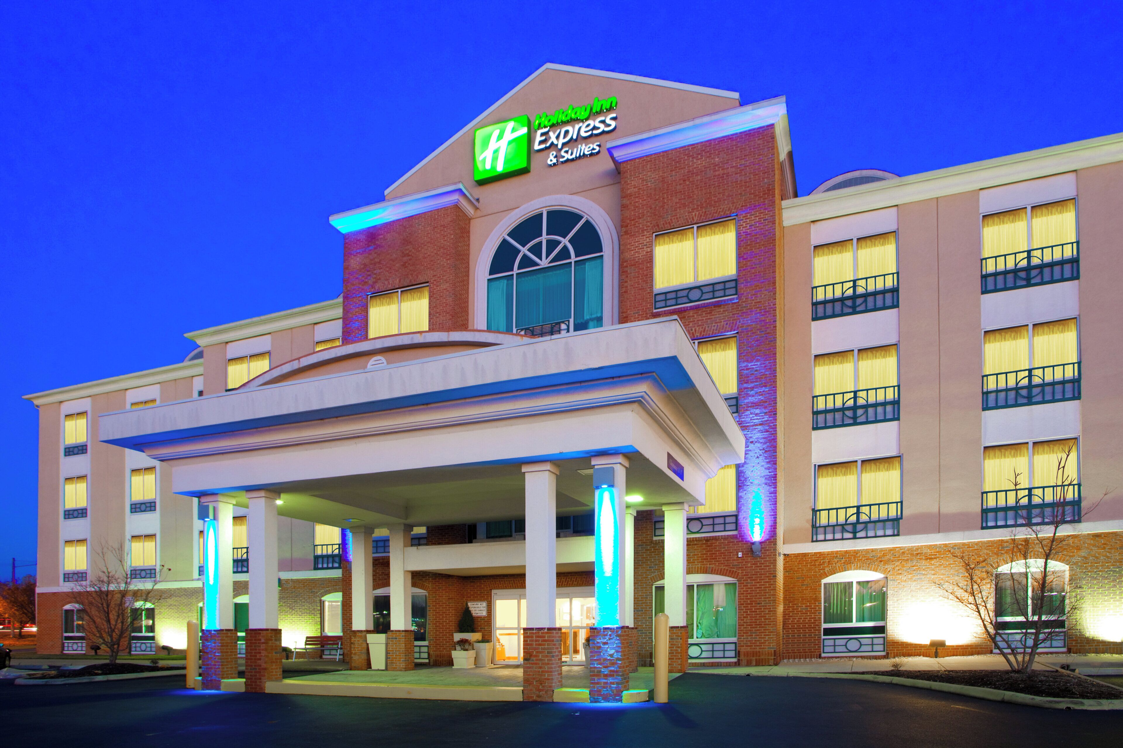 A Holiday Inn Express hotel with a prominent entrance, multiple balconies, and a well-lit facade.