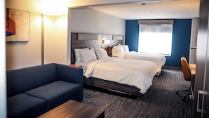 A hotel room with two beds, a sofa, a desk, and a lamp. - Holiday Inn Express Hotel & Suites Douglas by IHG (Douglas)