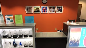 A hotel reception desk with a display of crystal figurines, informational signs, and a 'motel' sign on the wall.