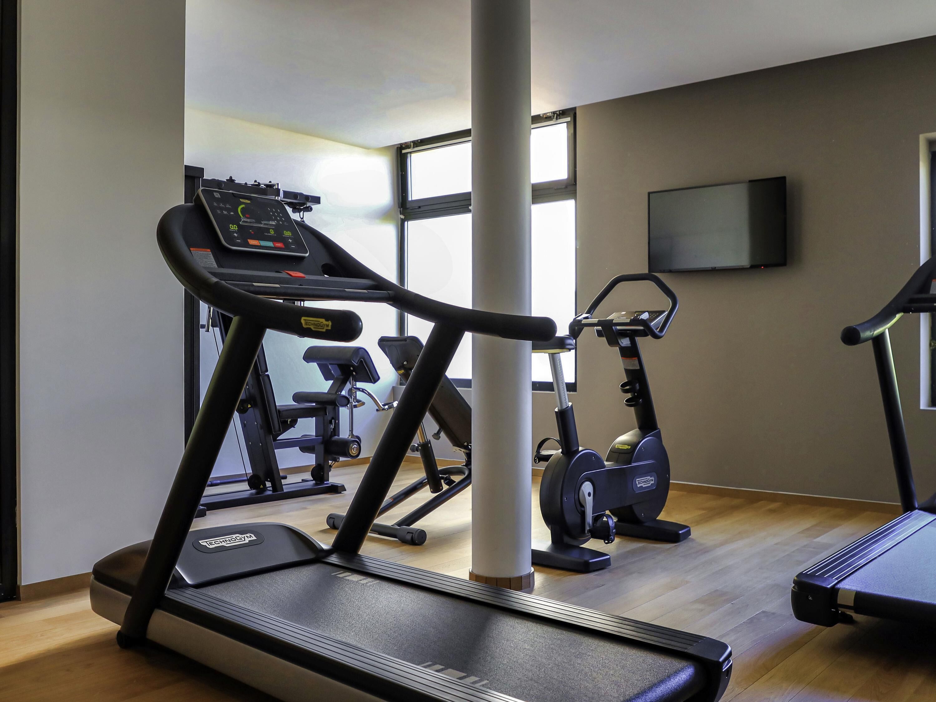 A gym with treadmills, ellipticals, and weight machines.