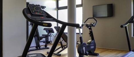 A gym with treadmills, ellipticals, and weight machines.
