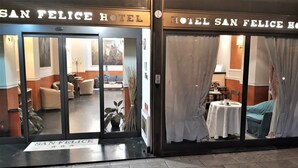 The exterior of the San Felice Hotel with a reception area visible through the glass doors. - Hotel San Felice (Bologna)