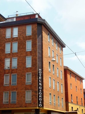 A multi-story hotel building with a prominent 'HOTEL GIORGIO' sign on the facade. - Hotel San Giorgio (Bologna)