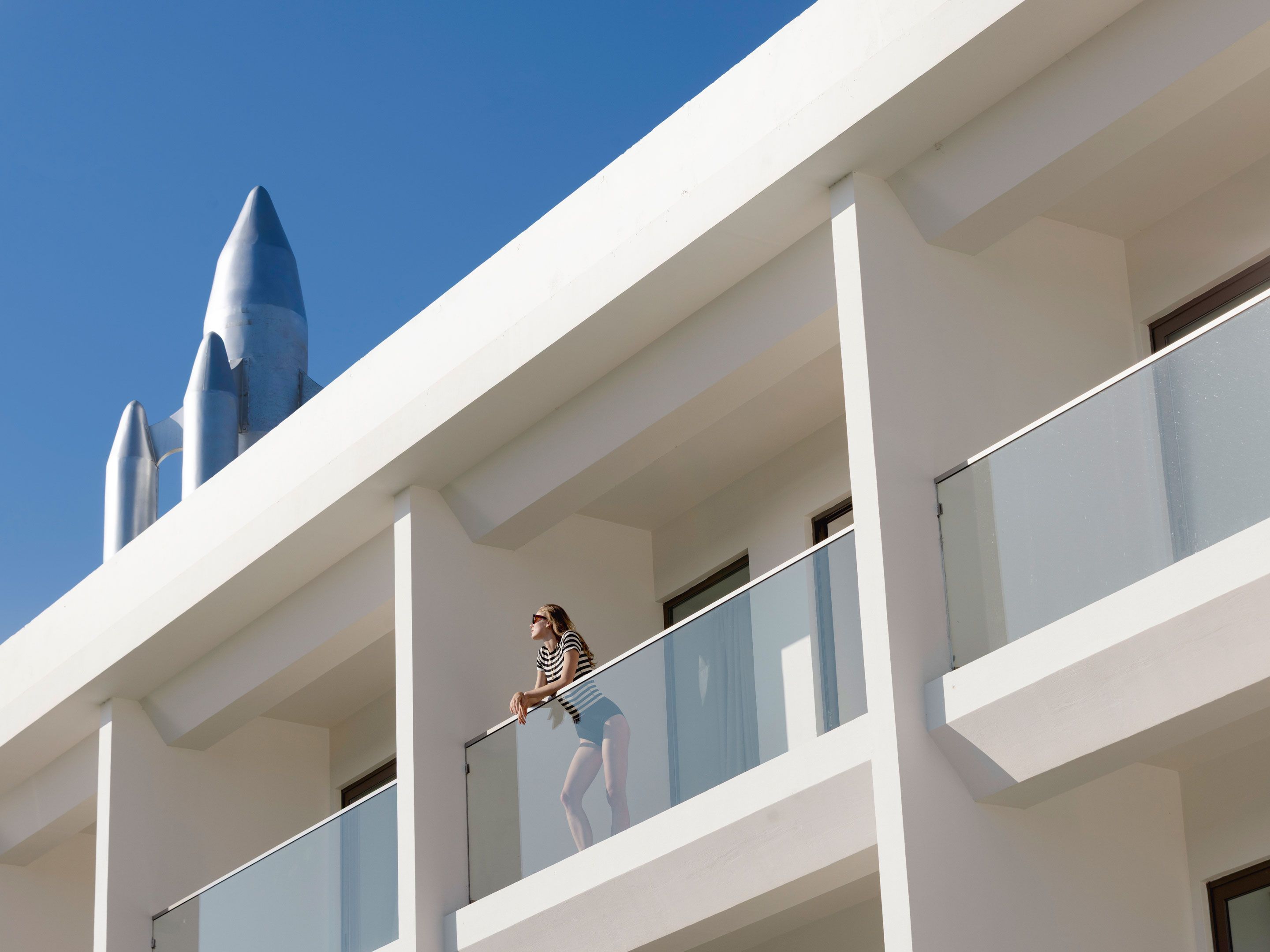 A modern building with a balcony and a clear sky.