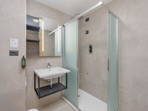 Eco-friendly toiletries, hair dryer, slippers, bidet