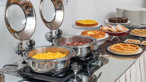 A buffet with various food items, including a cheese dish, a meat dish, and several desserts. - B&B HOTEL CALENZANO FIRST (Calenzano)