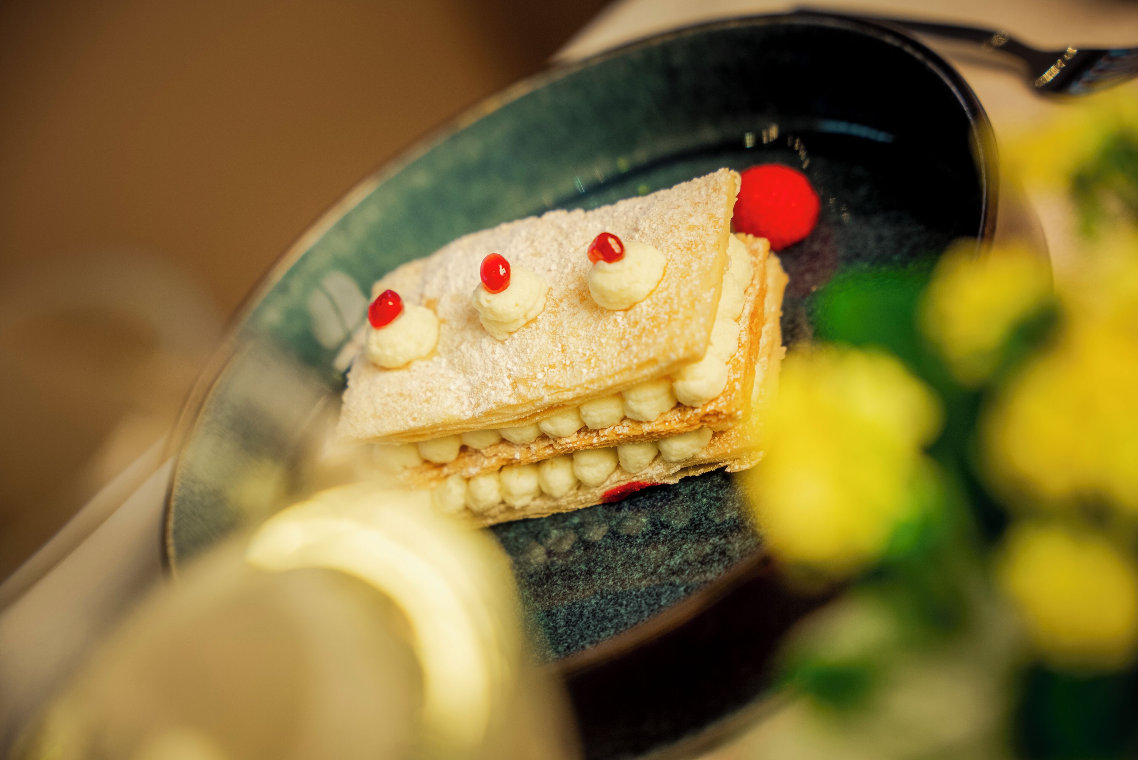 A dessert with whipped cream and cherries on a plate.