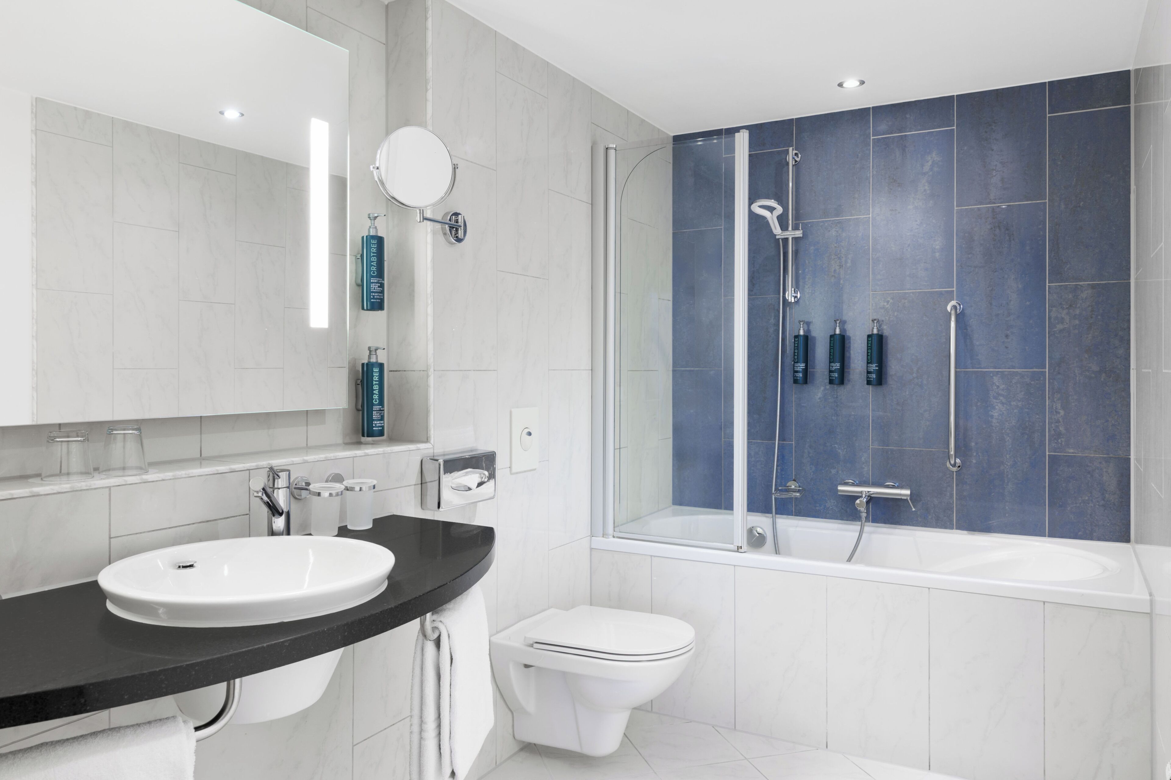 Ein modernes Badezimmer mit Waschbecken, Toilette und Badewanne.