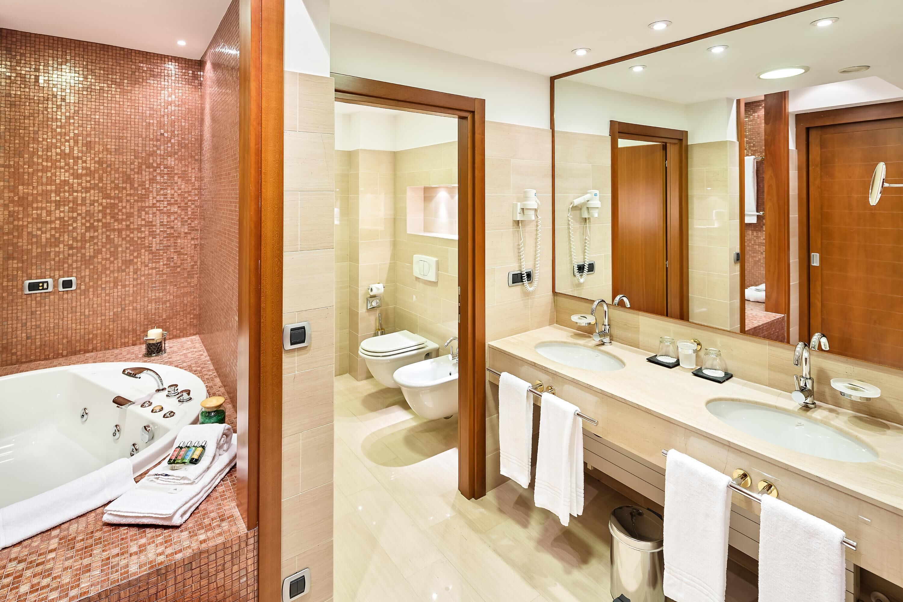 suite | bathroom | deep-soaking bathtub, hair dryer, slippers, towels