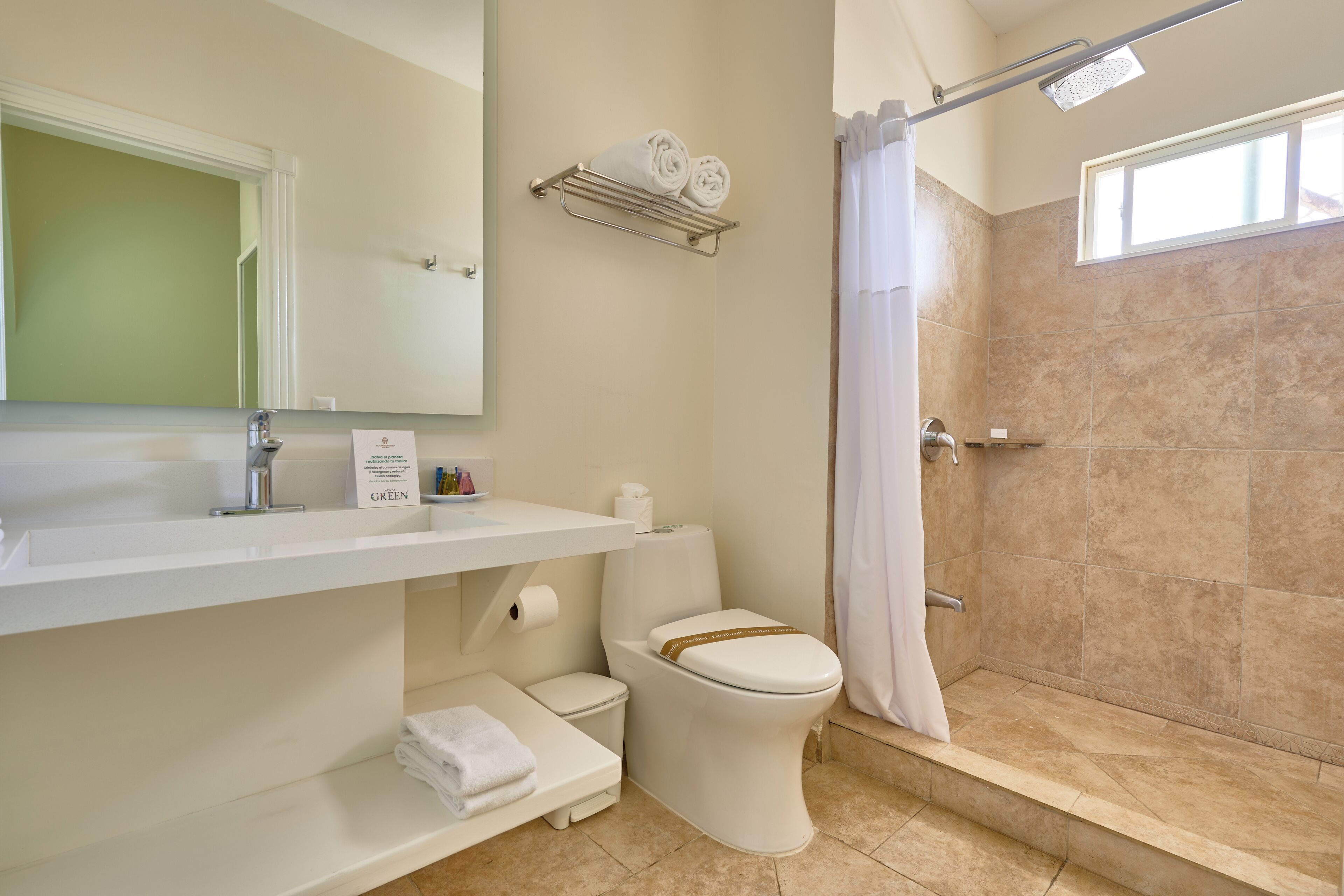 A bathroom with a shower, toilet, and sink.