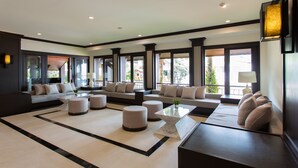 A spacious living area with a large sofa set, ottomans, and a coffee table. - Krabi Heritage Hotel (Krabi)