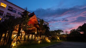 A hotel with a prominent sign, a well-lit entrance, and a clear view of the sky. - Krabi Heritage Hotel (Krabi)