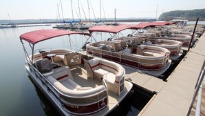 A marina with several pontoon boats docked. - Kenlake State Resort Park (Hardin)