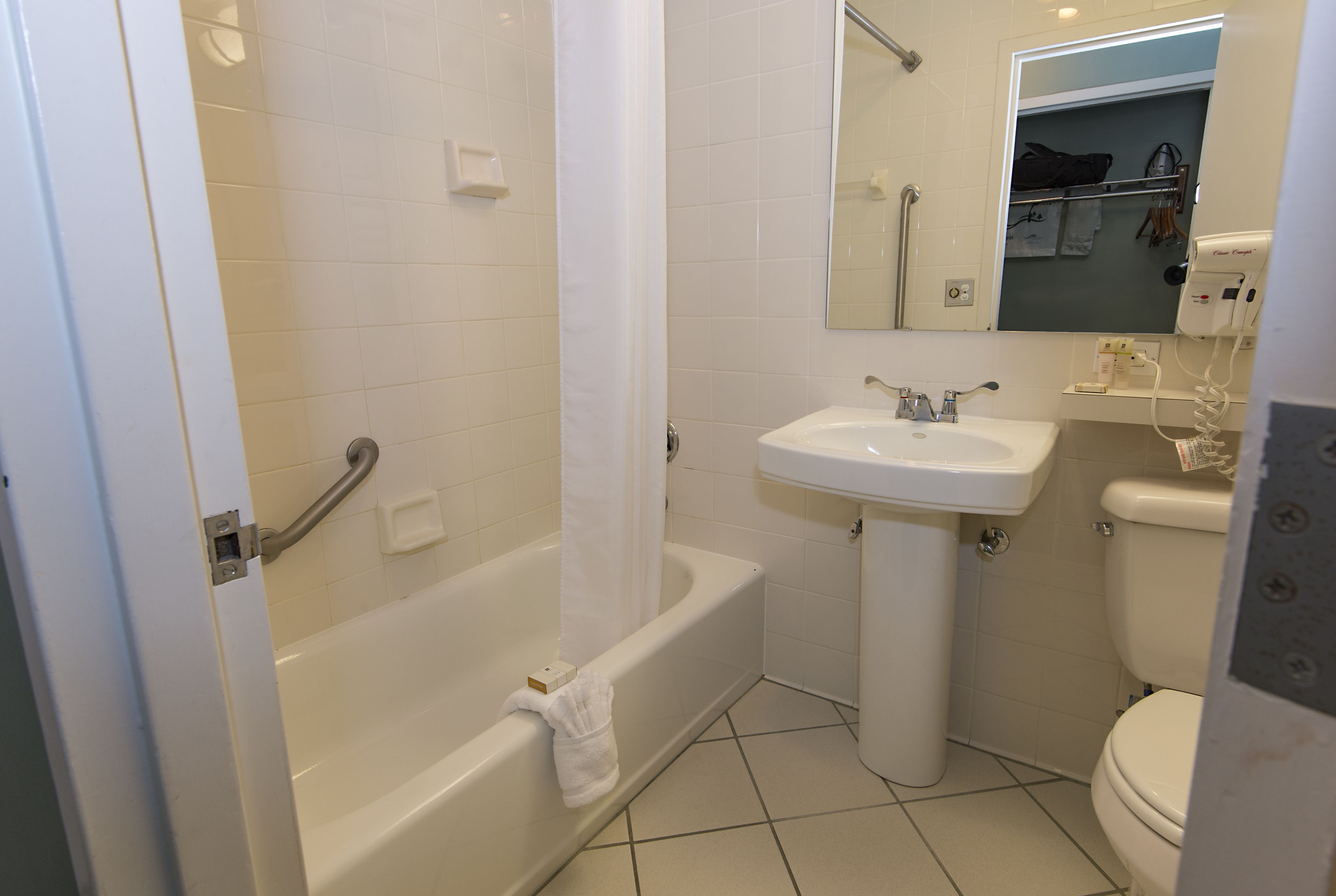 A bathroom with a bathtub, sink, and toilet.