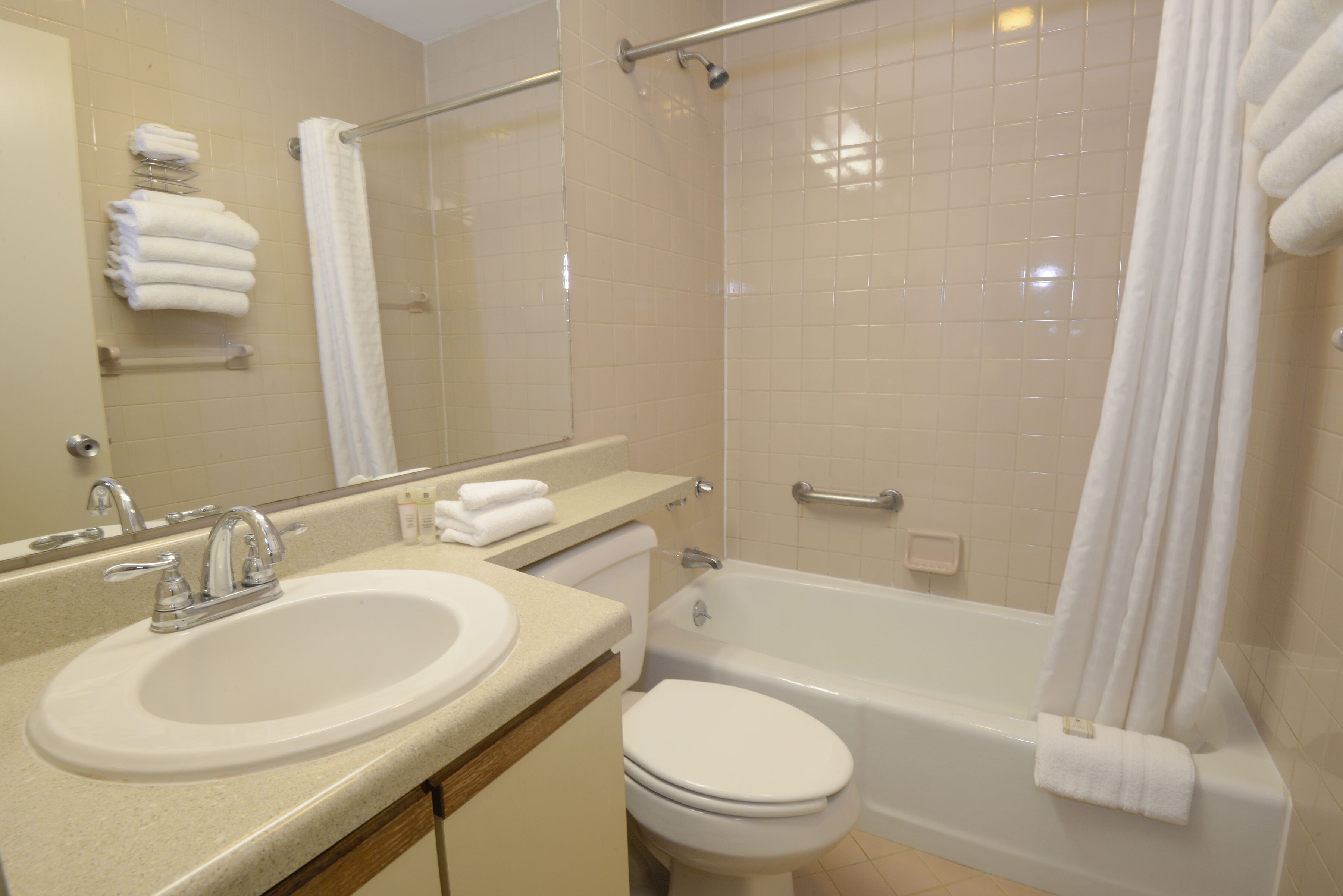 A bathroom with a sink, toilet, and bathtub.