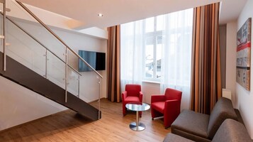 Executive Quadruple Room | Minibar, in-room safe, desk, blackout drapes