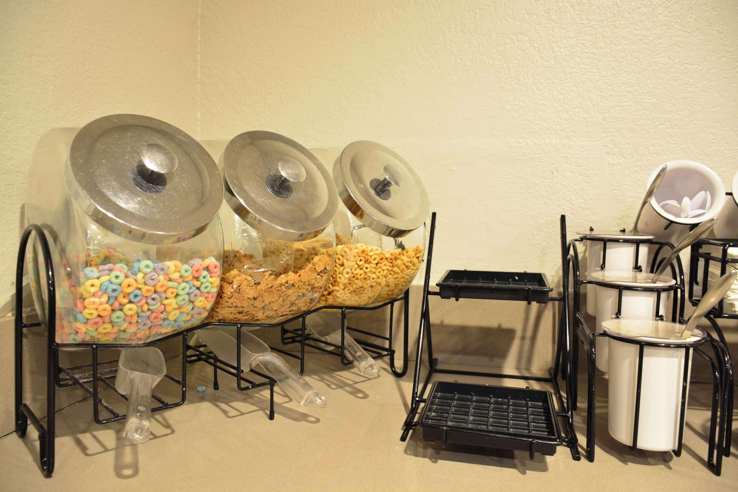 A buffet setup with cereal and cereal bars, a coffee station, and a tea station.