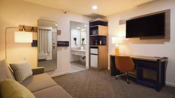 Suite, 1 King Bed, Non Smoking | Desk, laptop workspace, blackout drapes, iron/ironing board